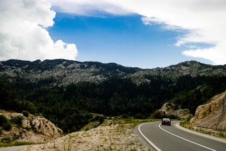 The lonley car on the road in Montenegroの写真素材