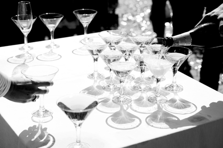 Man pours champagne in wineglassesの写真素材