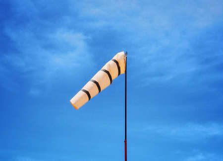 Wind direction bag and cloud in the blue sky is background.の写真素材