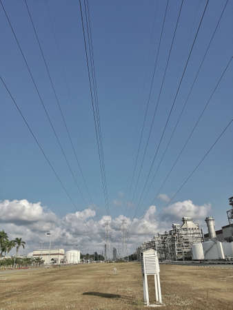 power plant is stand near the lawn under the blue sky and the Cloud, Thailand