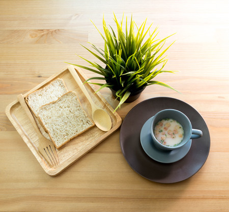cup soup with bread breakfast on the wood tableの写真素材