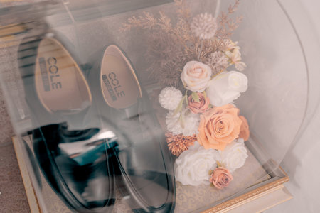 wedding bouquet of flowers and shoes on the glass tableの写真素材