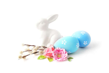 colorful easter eggs and spring flowers isolated on white background