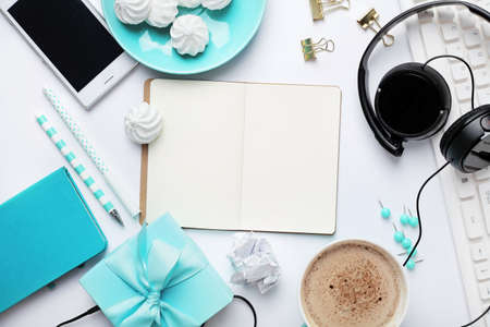 workspace with notebook keyboard, sketchbook, diary, coffee on white background. Flat lay, top view office table desk.の写真素材
