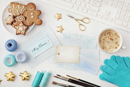 christmas workspace with notebook keyboard, sketchbook, christmas gifts wrapping. flat lay