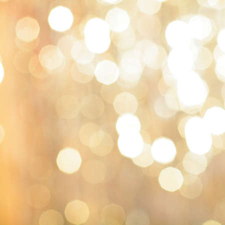golden backdrop, christmas bokeh lights. abstract refocused blurred background.の写真素材