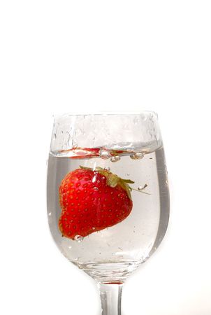Strawberry in the water on white background in the glassの写真素材
