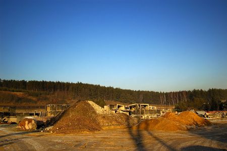 	Industrial landscape with building gravel and blue skyの写真素材
