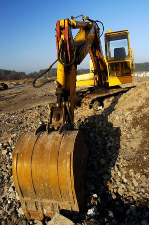 	Digger dig out in industrial landscapeの写真素材