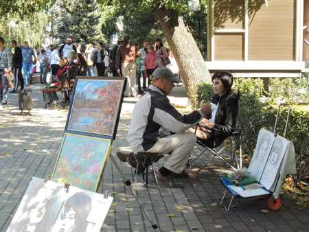 artist draws a pencil portrait of a young womanのeditorial素材
