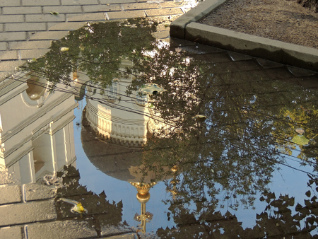 Rain puddle and reflection of the cupola of an Orthodox Churchの写真素材