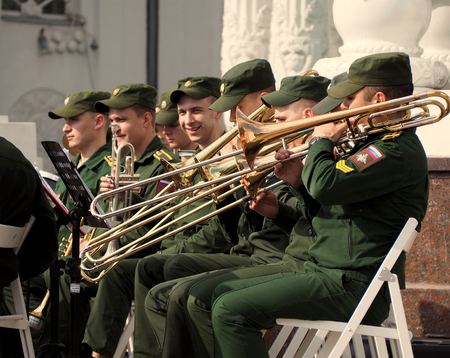 Military brass band trombonists and trumpet players during the performance.  Festival of military orchestras "Spasskaya Tower". Central Avenue in the Park of VDNH, Moscow.のeditorial素材