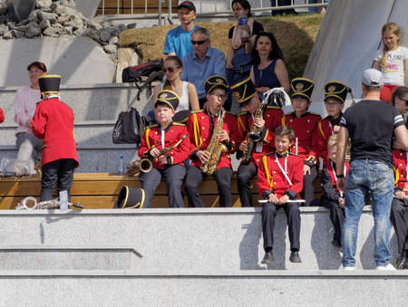 Moscov, Russia - May 12, 2018: Young musicians sit among the audience in the stands of an open amphitheater in the Park Zaryadye. Festival of military orchestrasのeditorial素材