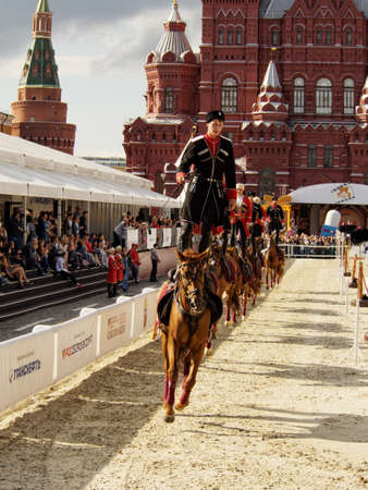 Moscow, Russia - Sep 3, 2016: A group of riders in Circassians and papakhas performs a trick riding standing on Bay horses near the State Historical Museum. Festival Spasskaya Towerのeditorial素材