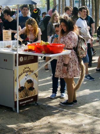 Voronezh, Russia - May 1, 2018: Adult girl with elements of clothing and makeup of an anime character standing with other park visitors at a food kiosk. All-Russian festival of Japanese animation.のeditorial素材