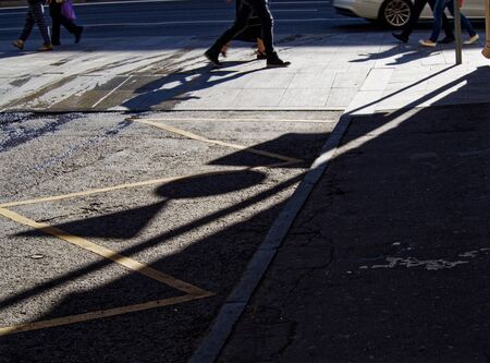 Pedestrians at the intersection of city streetsの写真素材