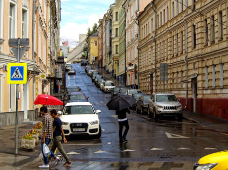 Moscow, Russia - July 8, 2018: Pedestrians on a pedestrian crosswalk in the rainのeditorial素材