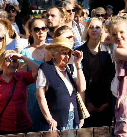 Moscow, Russia, June 16, 2018: An elderly woman in a straw hat standing in a crowd of peopleのeditorial素材