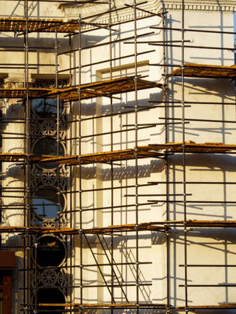 Reconstructed wall of building with decorative elements in scaffoldingの写真素材