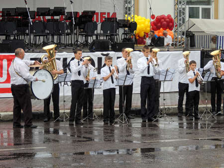 Voronezh, Russia - May 31, 2015: Teacher and his pupils play in the rain on the Music Festival of Children's Brass Bands on the city central squareのeditorial素材