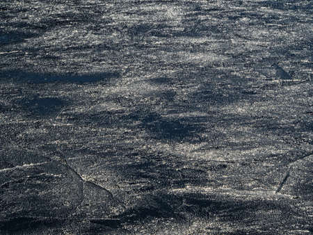 Ice-covered water surface in sunlightの写真素材