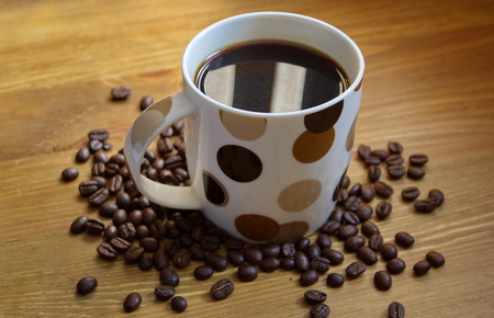 cup of coffee with beans on the tableの写真素材