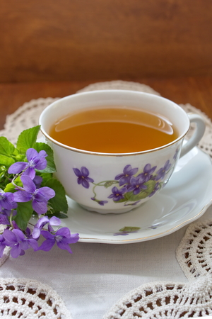 vintage tea cup with violetsの写真素材