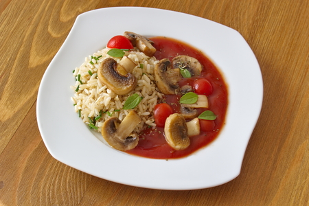 whole grain rice with tomato sauce and mushroomsの写真素材