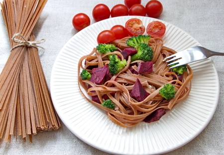whole grain spaghetti, fresh broccoli, beetroot and sunflower seedsの写真素材