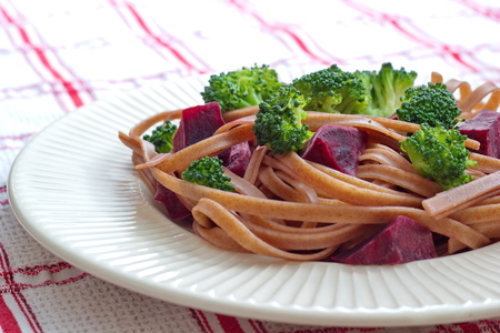 Dark pasta with cooked beetroot and broccoliの写真素材