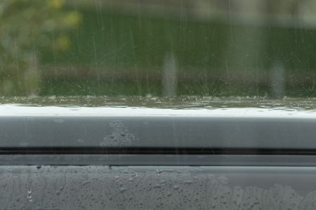 rain drops beat a car roof
