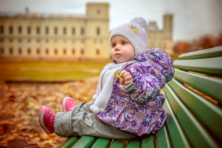 happy little child, baby girl laughing and playing in the autumn on the nature walk outdoorsの写真素材