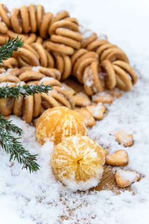 tangerines in snow on a wooden table, new year, a still lifeの写真素材