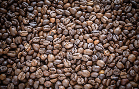 coffee grains on grunge wooden backgroundの写真素材