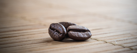 coffee grains on grunge wooden backgroundの写真素材