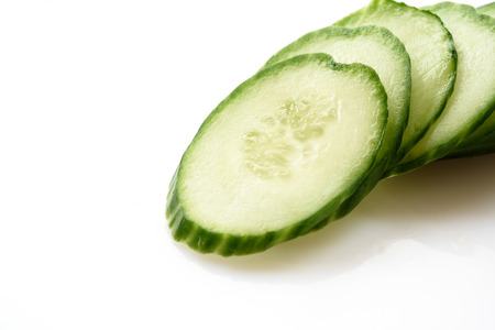 Cucumber and slices isolated over white background.の写真素材