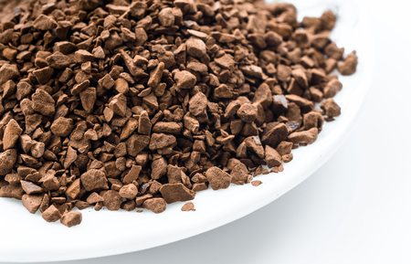 Instant coffee granules isolated on white backgroundの写真素材