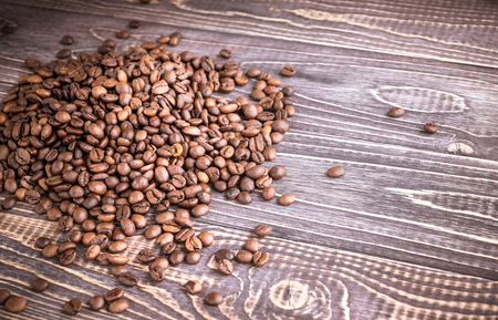 Background with coffee beans and wood textureの写真素材