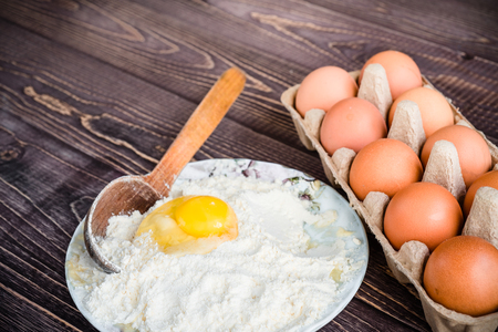 flour and eggs for pastries on a wooden background, retro styleの写真素材