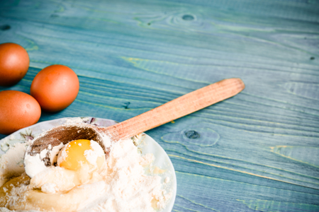 flour and eggs for pastries on a wooden background, retro styleの写真素材