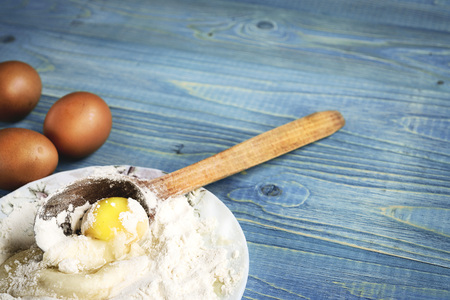 flour and eggs for pastries on a wooden background, retro styleの写真素材