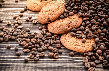 Fresh biscuits and coffee beans on a wooden backgroundの写真素材
