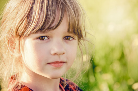 Summer portrait of a small red-haired girlの写真素材