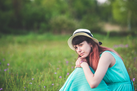 Girl, nature, walk and travel concept-beautiful girl in a field with flowersの写真素材