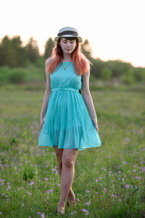 Girl, nature, walk and travel concept-beautiful girl in a field with flowersの写真素材