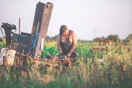 Farmer working in the field on a tractor - the concept of agricultureの写真素材