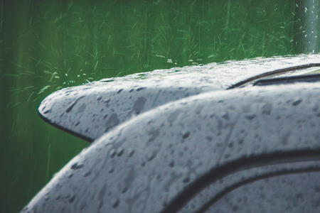 Splashes of rain from the roof of the car, closeupの写真素材