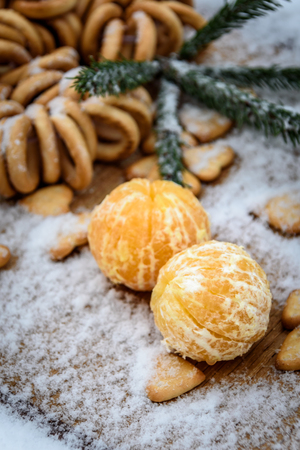 Mandarins, snow, spruce branches - Christmas background and concept of the new compositionの写真素材