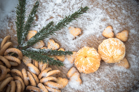 Mandarins, snow, spruce branches - Christmas background and concept of the new compositionの写真素材