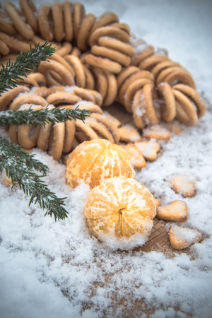 Mandarins, snow, spruce branches - Christmas background and concept of the new compositionの写真素材